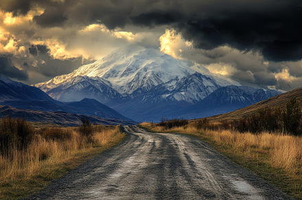 Unpaved road winds through lush vall, a Photo by Iftikhar Alam