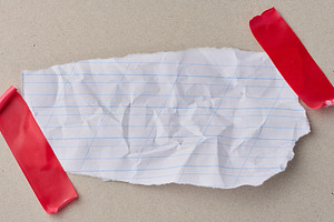 A scrap of white notebook paper with diagonal lines, attached wi, an Abstract Photo by ndanko