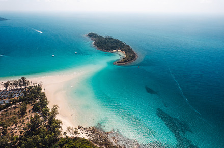 Tropical island from above and clear blue sea, a Nature Photo by Art Rachen