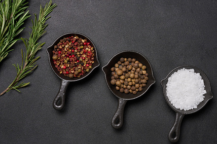 Miniature pans with spices, salt, black pepper and fragrant pepp, a Food & Drink Photo by ndanko