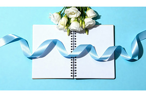 Open notebook with white flowers and, a Background Photo by tilialucida