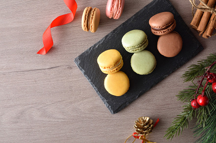 Assorted macaroons on wooden table with Christmas decoration top, a Food & Drink Photo by Davizro's Market