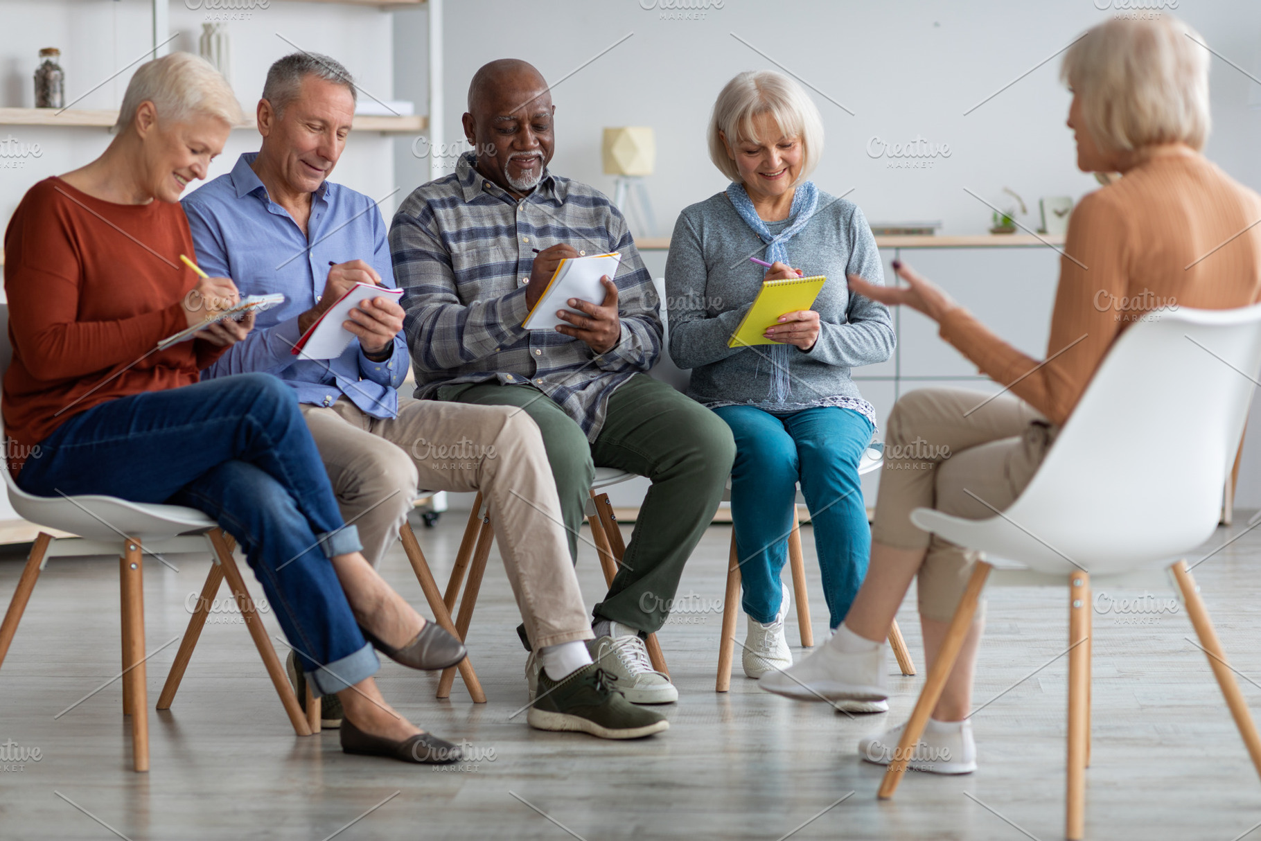Multiracial group of elderly men and women having educational class, a Photo by Prostock-Studio