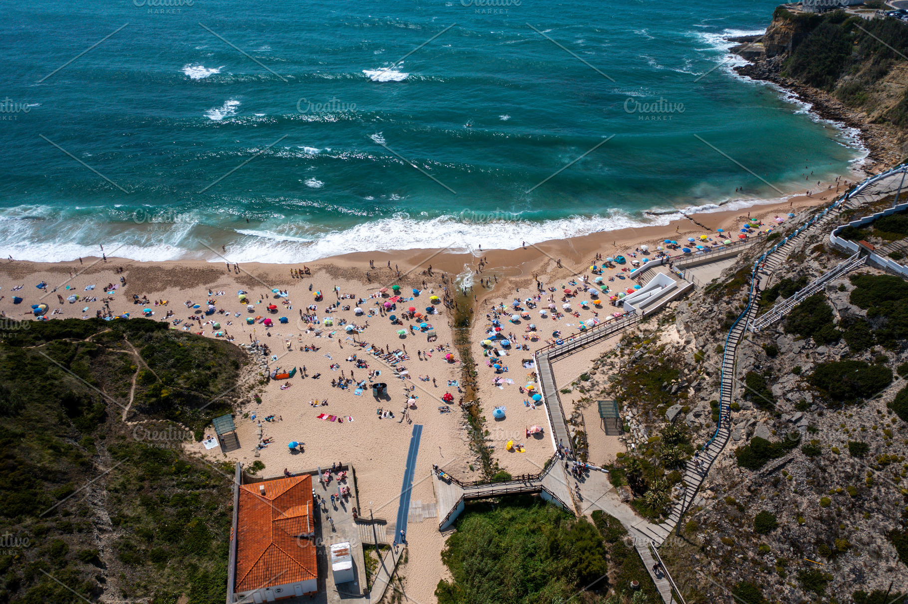 Aerial drone view of anonymous tourists at scenic Magoito Beach, a Photo by andreonegin market
