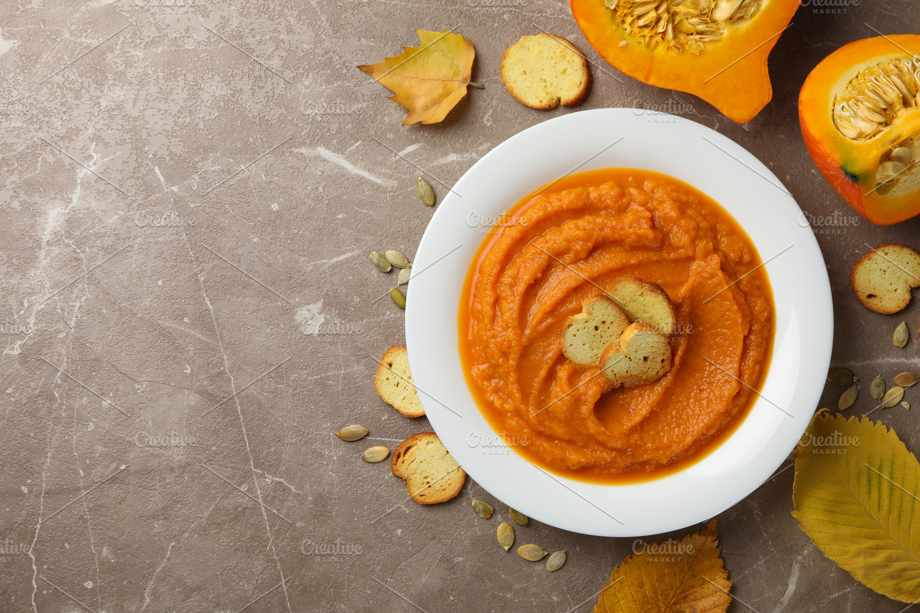 Composition with plate of pumpkin puree with croutons on gray ba, a Food & Drink Photo by AtlasStudio PRO