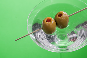 Skewered two olives in a glass with
