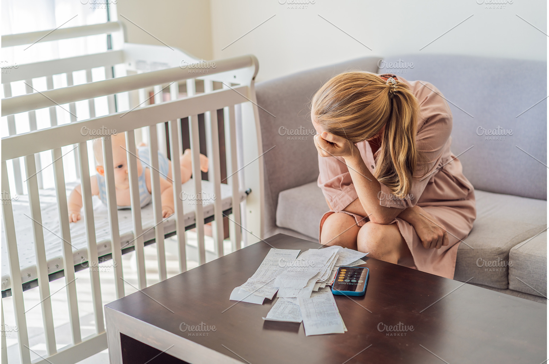 Mother sitting on sofa calculating, a Business Photo by Elizaveta Galitskaya