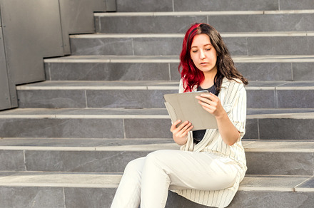 Woman with Digital Tablet on stairs, a Person Photo by Andriana Syvanych