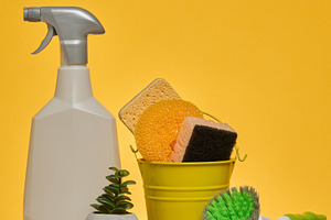 White plastic spray bottle and a stack of multi-colored sponges, a Background Photo by ndanko