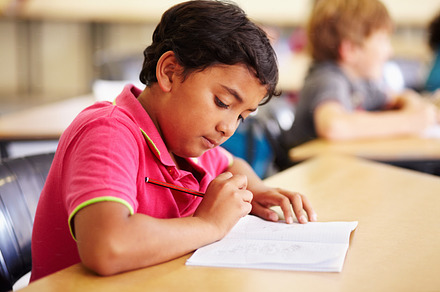 Focussing on his homework, a Photo by Peopleimages.com