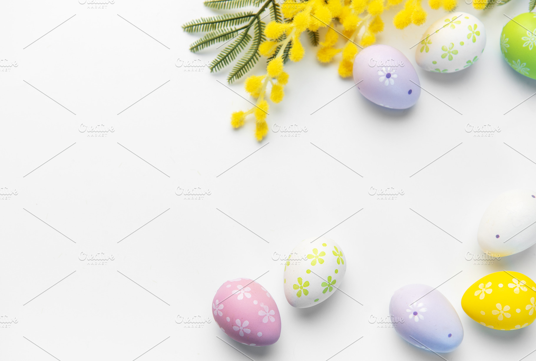 Decorated easter eggs and mimosa flowers on white background, a Holiday Photo by Olena Rudo