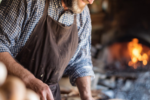Smiling mature chef cooking meat in, a Food & Drink Photo by MistyDay