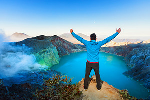 Man stand above kawah ijen volcano containing kawah, ijen, and volcano