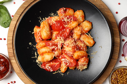 Concept of tasty food with gnocchi, top view, a Food & Drink Photo by AtlasStudio