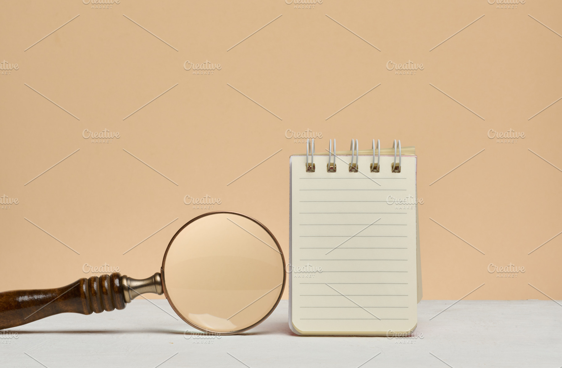 An open notebook with blank lined sheets of paper and a magnifyi, a Business Photo by ndanko