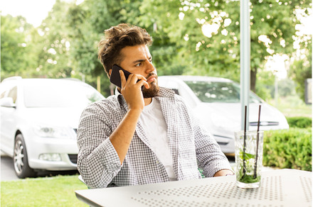Confident young man talking by phone, a Person Photo by oksix