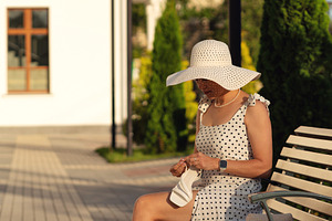 Woman in polka dot dress sitting on, a Beauty & Fashion Photo by Elena Vagengeim