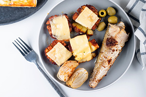 baked potatoes with cheese and fried fish on plate for lunch, a Food & Drink Photo by vimart