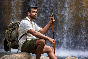 Explorer resting in front of a water, a Person Photo by Perpis