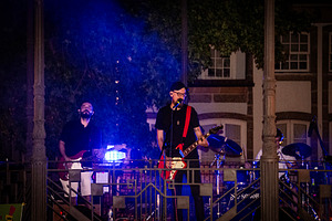 Live music performance at night with dramatic blue lighting, a Person Photo by DanFLCreativo