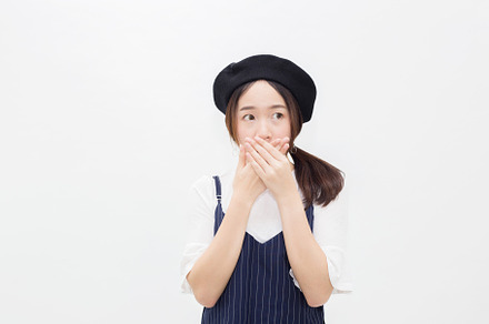 Asian female person covering her mouth in white isolated background, a Person Photo by Twinster Photo