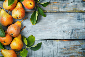 Red pears with leafs and copyspace for text on wooden table, a Food & Drink Photo by AlyaAnd