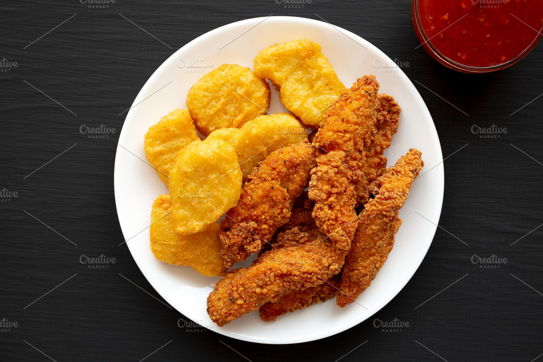 Homemade Nuggets and Chicken Tenders with Sweet and Sour Sauce o, a Food & Drink Photo by LiudmylaChuhunova