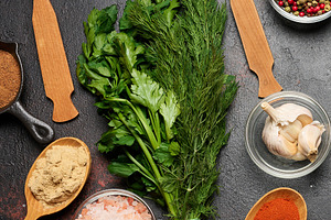 Spices, herbs, and garlic on a dark background. Turmeric, paprik, a Food & Drink Photo by ndanko