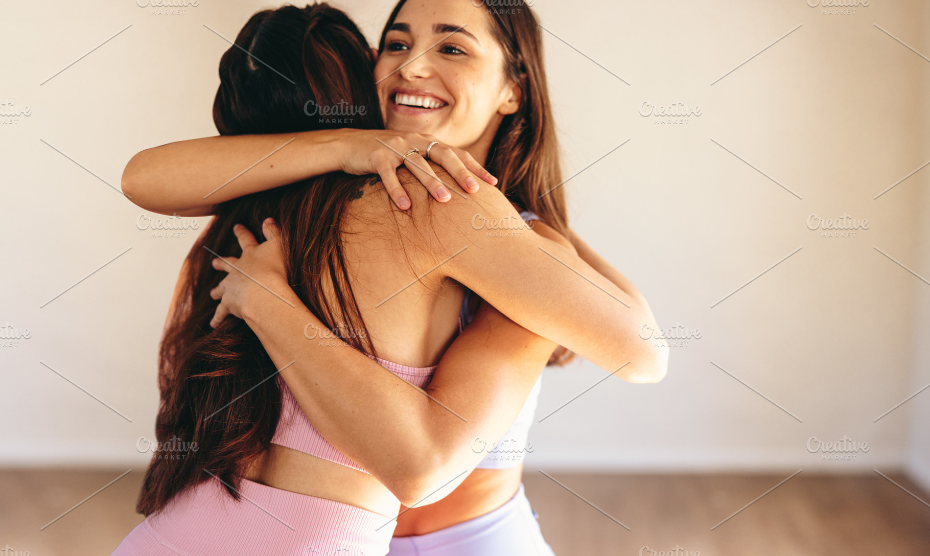 Two young women hugging each other after a yoga class, a Person Photo by Jacob Lund