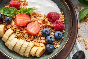 Healthy breakfast bowl with yogurt, granola, fresh berries and b, a Food & Drink Photo by Olena Rudo