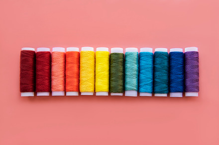 Spools of thread on the colors of th containing spool, thread, and sewing, an Industrial Photo by Olena Rudo