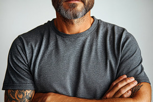 Man with crossed arms and a beard po, a Photo by Tanuart