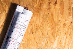 Construction plans on wooden table containing blueprint, plan, and apartment, an Architecture Photo by Sainath Chillapuram