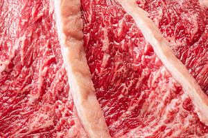 Sliced picanha beef with spices and herbs on a gray stone servin, a Food & Drink Photo by Volff