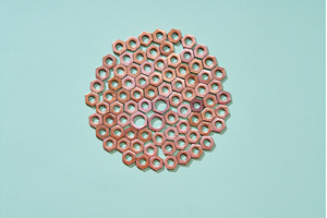 Arrangement of metal nuts in a, an Industrial Photo by Gladkov photography