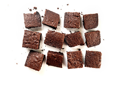 Many pieces of fresh chocolate brownie on a white table. Homemad, a Food & Drink Photo by vimart