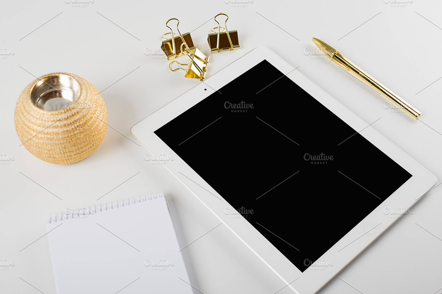 Tablet and notebook next to ballpoint pen and golden clips on white background., a Business Photo by José Luis Agudo