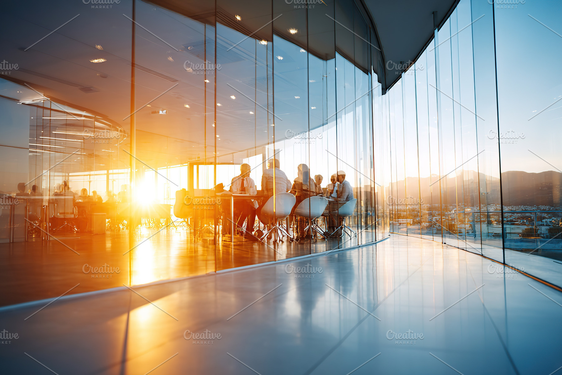 Modern open space office features glass walls and a sunset view over the city, a Photo by AlyaAnd