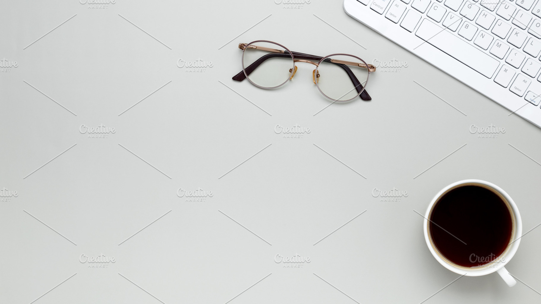 Minimal morning workspace with coffee cup, keyboard, and glasses fostering focu, a Photo by matucha
