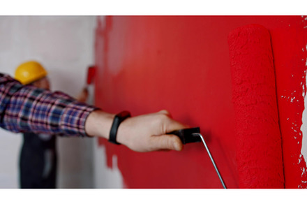 Family covering wall in red paint in, a Person Photo by Barcelona_dreams