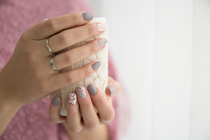 Woman's hands holding a cup containing mug, cup, and pink