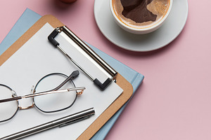 Coffee break accessories arranging on pink table with cactus pla, a Business Photo by Olena Rudo