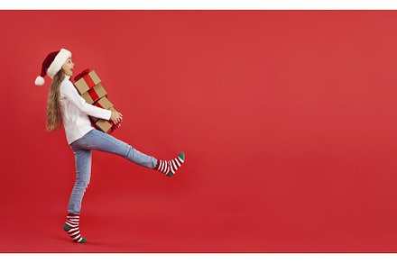 Happy little girl carrying stack of, a Person Photo by StudioRomantic