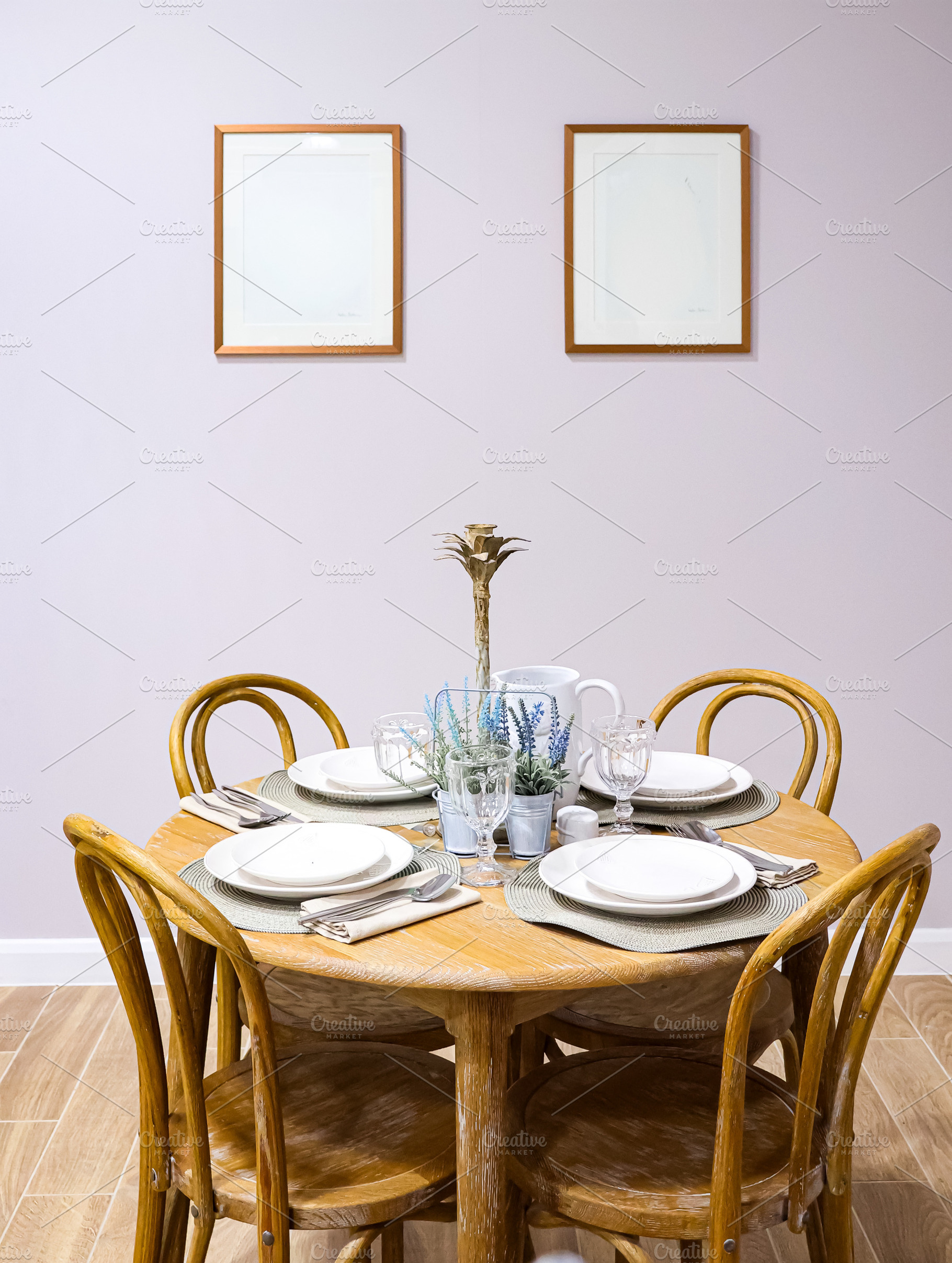 Dining table set with wooden chairs and white plates in a minimalist home inter, a Photo by Studio ANNA