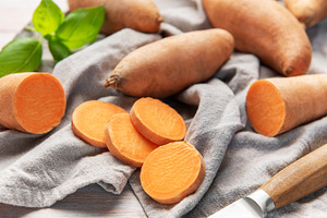 Sweet potato slices with whole root vegetables and basil, a Food & Drink Photo by Olena Rudo