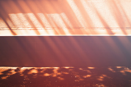 Sunset dramatic light beams on street wall background, an Abstract Photo by RETROWAVE '88