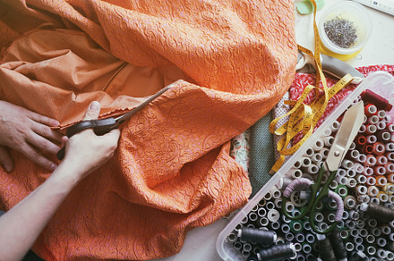girl cutting orange fabric, a Beauty & Fashion Photo by Koldunova