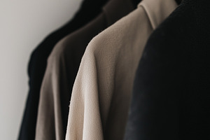 Minimalist neutral shirts hang on a, a Beauty & Fashion Photo by MistyDay