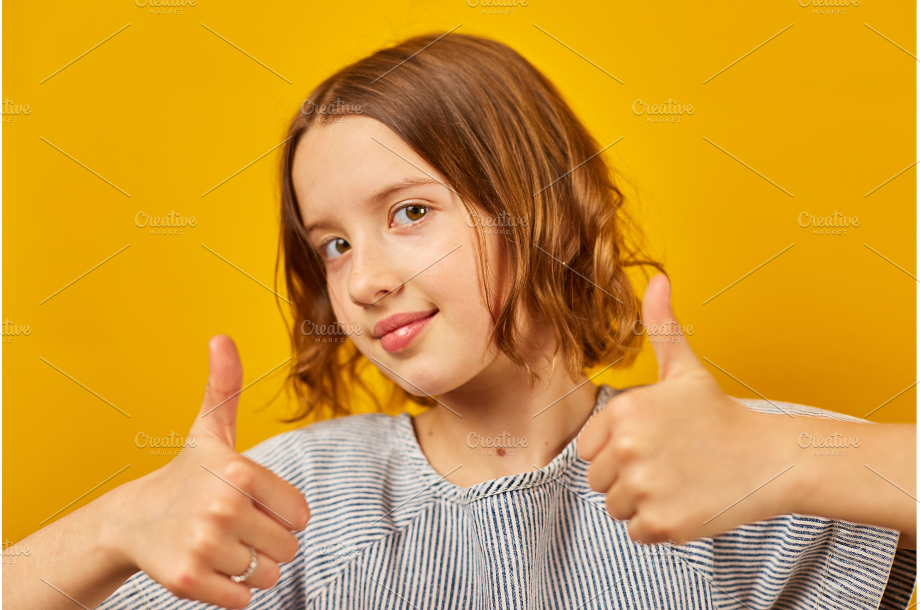 Young girl giving thumbs up with a, a Beauty & Fashion Photo by IlliaBondarPhotography