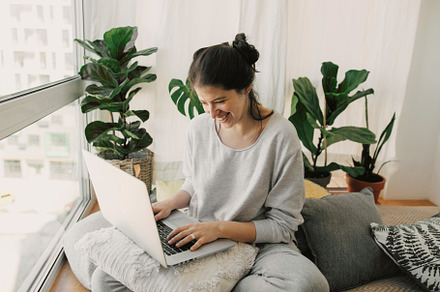 Happy girl working on laptop, a Person Photo by Sonjachni